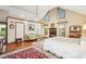 Main bedroom with high ceilings, a fireplace, loveseat, and hardwood floors at 100 Deer Cv, Fayetteville, GA 30214