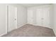 Empty bedroom with carpeted floor and double door closet at 11820 Rizvan Pl, Covington, GA 30014