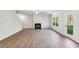 Spacious living room featuring hardwood floors and a cozy fireplace at 11830 Rizvan Pl, Covington, GA 30014