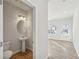 Convenient half bathroom with pedestal sink and round mirror at 11834 Rizvan Pl, Covington, GA 30014