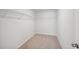Spacious walk-in closet with wire shelving and neutral carpeting at 11834 Rizvan Pl, Covington, GA 30014