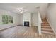 Living room with fireplace, vinyl flooring, and ceiling fan at 11834 Rizvan Pl, Covington, GA 30014