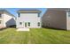 Two-story house with gray siding, backyard, and patio at 11834 Rizvan Pl, Covington, GA 30014