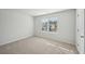 Well-lit bedroom with neutral carpeting and a window providing natural light at 11834 Rizvan Pl, Covington, GA 30014