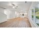 Open living room with hardwood floors, kitchen island, and access to backyard at 11834 Rizvan Pl, Covington, GA 30014