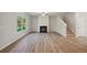 Living room with fireplace, vinyl flooring, and ceiling fan at 11834 Rizvan Pl, Covington, GA 30014