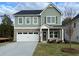 Two-story home with gray siding, brick accents, and a two-car garage at 11834 Rizvan Pl, Covington, GA 30014
