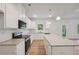 Bright kitchen with white cabinets and granite countertops at 11834 Rizvan Pl, Covington, GA 30014