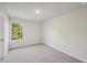 Spacious bedroom with neutral walls and carpeting, plus a large window at 11834 Rizvan Pl, Covington, GA 30014