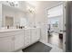 Double vanity bathroom with view of bedroom and hardwood floors at 10120 Windalier Way, Roswell, GA 30076