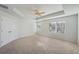 Bright main bedroom with high ceilings, ceiling fan and carpet flooring at 11814 Rizvan Pl, Covington, GA 30014