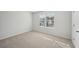 Spacious bedroom with neutral carpeting and large window at 11814 Rizvan Pl, Covington, GA 30014