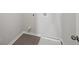 Bright laundry room with washer and dryer hookups, and modern tile flooring at 11814 Rizvan Pl, Covington, GA 30014