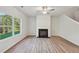 Living room with hardwood floors, fireplace and ceiling fan at 11814 Rizvan Pl, Covington, GA 30014