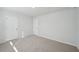 Well-lit bedroom featuring neutral walls and plush carpeting at 11814 Rizvan Pl, Covington, GA 30014