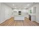 Open concept kitchen with white cabinets and granite countertops at 11814 Rizvan Pl, Covington, GA 30014