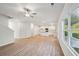 Open living room with LVP flooring, kitchen island, and access to backyard at 11814 Rizvan Pl, Covington, GA 30014
