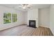 Living room with hardwood floors, fireplace, and ceiling fan at 11814 Rizvan Pl, Covington, GA 30014