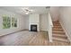 Living room with hardwood floors, fireplace, and ceiling fan at 11814 Rizvan Pl, Covington, GA 30014