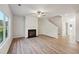 Spacious living room with hardwood floors, fireplace and ceiling fan at 11814 Rizvan Pl, Covington, GA 30014