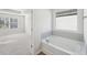 Bathroom with soaking tub, double vanity, and view of bedroom at 11814 Rizvan Pl, Covington, GA 30014