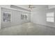 Large main bedroom with ceiling fan, multiple windows, and plush carpeting at 11814 Rizvan Pl, Covington, GA 30014