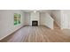 Living room with hardwood floors, fireplace and ceiling fan at 11814 Rizvan Pl, Covington, GA 30014