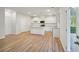 Bright kitchen with white cabinets, granite countertops, and island at 11814 Rizvan Pl, Covington, GA 30014