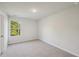 Well-lit bedroom with carpet and a window offering natural light at 11814 Rizvan Pl, Covington, GA 30014