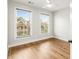 Well-lit bedroom with hardwood floors and two windows at 370 Thrasher St # 2, Norcross, GA 30071