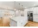 Modern kitchen with white cabinets, an island, and hardwood floors at 370 Thrasher St # 2, Norcross, GA 30071