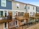 Rear view of townhouses with private decks and fenced yards at 370 Thrasher St # 2, Norcross, GA 30071