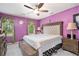 Main bedroom with plush carpet, large bed, and ceiling fan at 1911 Geyser Trce, Lawrenceville, GA 30044