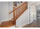 Elegant staircase with wood railing and hardwood treads at 14020 Tributary Ln, Villa Rica, GA 30180