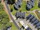 Aerial view of townhomes near a road and lake, showcasing a community setting at 14020 Tributary Ln, Villa Rica, GA 30180