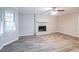 Living room featuring a brick fireplace and wood-look floors at 1507 Hillside Se Dr, Conyers, GA 30094