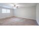 Spacious bedroom with ceiling fan and carpet flooring at 1507 Hillside Se Dr, Conyers, GA 30094