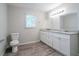 Bathroom with granite countertop and white cabinets at 1507 Hillside Se Dr, Conyers, GA 30094