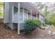 Gray brick house with white porch and landscaping at 1507 Hillside Se Dr, Conyers, GA 30094