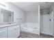 Bathroom with white vanity, bathtub, and shower at 1507 Hillside Se Dr, Conyers, GA 30094