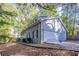 Gray house with a two-car garage and landscaping at 1507 Hillside Se Dr, Conyers, GA 30094