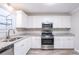 Updated kitchen with white cabinets and granite countertops at 1507 Hillside Se Dr, Conyers, GA 30094
