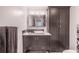 Modern bathroom with dark vanity, patterned tile, and built-in storage at 3638 Peachtree Ne Rd # 304, Atlanta, GA 30319