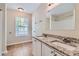 Bathroom with double vanity, granite countertop, and tile floor at 9170 Jefferson Sw Ave, Covington, GA 30014