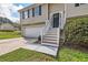 Front view of a tan house with a white garage and steps at 9170 Jefferson Sw Ave, Covington, GA 30014