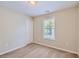 Well-lit bedroom with neutral walls and carpet flooring at 9170 Jefferson Sw Ave, Covington, GA 30014
