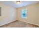 Simple bedroom with neutral walls and carpeted floor at 9170 Jefferson Sw Ave, Covington, GA 30014