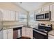 Modern kitchen with granite countertops and stainless steel appliances at 9170 Jefferson Sw Ave, Covington, GA 30014