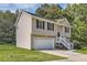 Tan house with a white garage door and white stairs at 9170 Jefferson Sw Ave, Covington, GA 30014
