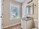 Clean bathroom with single vanity, granite countertop and tile floor at 9170 Jefferson Sw Ave, Covington, GA 30014